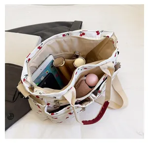 Interior view of cherry print tote bag showing large capacity and multi-pocket storage