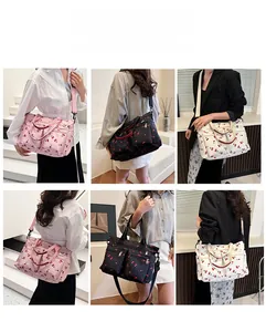 Multiple carrying options for this cherry print tote bag with adjustable shoulder straps