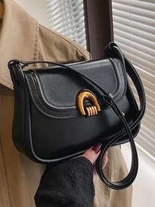 Retro black leather saddle bag for women with golden horseshoe buckle and flap closure