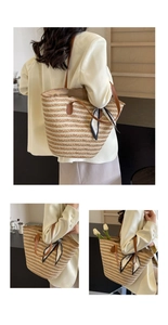 Detail of woven straw tote bag with brown leather handles and printed silk scarf