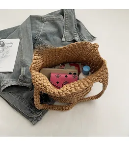 Vue de dessus d'un sac cabas tissé main montrant l'intérieur spacieux et les objets