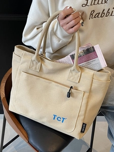 Minimalist beige canvas tote bag with side pockets and large capacity for daily commuting