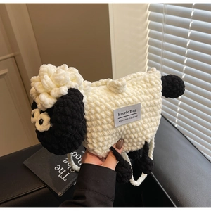 Detail of handmade crochet sheep bag showing wool texture and Faerie Bag brand label