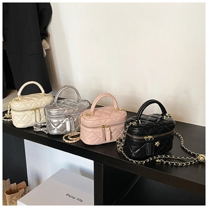 Detailed row of quilted vanity bags in cream, silver, pink, and black colors