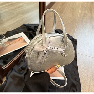 Macro shot of silver bowling bag with lychee texture and Just For You ribbon detail