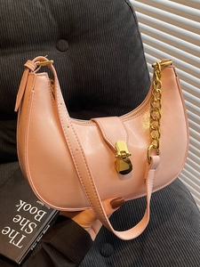 Pink glossy saddle shoulder bag with chunky gold chain strap and metal lock closure