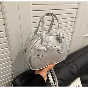 Detailed macro view of silver litchi grain texture on bowling bag with a decorative bow