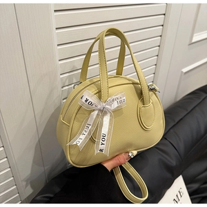 Detail of lychee textured leather bowling bag with decorative JUST FOR YOU ribbon bow