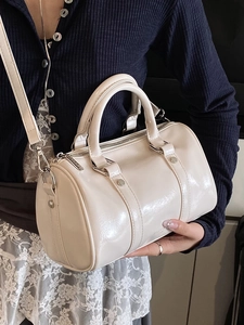 Creamy glossy Boston bag with top handles and shoulder strap for a minimalist look