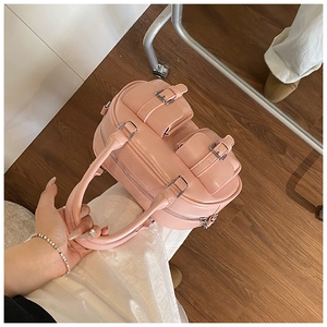 Pink Boston handbag featuring double front pockets with metal buckles and silver hardware