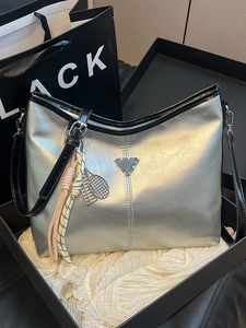 Metallic silver leather tote bag with triangle logo and tennis racket charm accessory