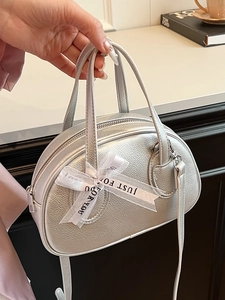 Chic silver bowling handbag with lychee texture and decorative ribbon on handle