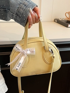 Minimalist lemon yellow bowling handbag with litchi texture and decorative ribbon tie
