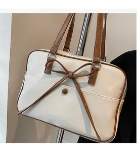 Detail view of contrast ballet style tote bag with ribbon bow and two-tone stitching