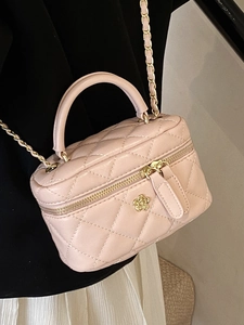 Pink quilted leather vanity box bag with golden camellia charm and chain strap