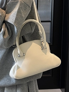Chic shell-shaped toasted crossbody bag in cream leather with an arched handle for women