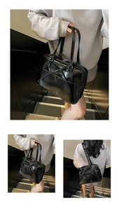 Detail view of the black glossy patent leather tote with delicate bow design details