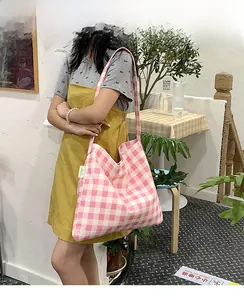 Pink and white checkered tote bag detail on shoulder showing large capacity and soft fabric