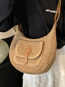 Bohemian woven straw half-moon crossbody bag with leather strap for beach vacations