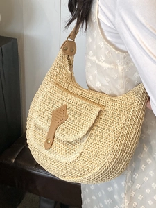 Straw hobo shoulder bag with leather pocket detail for a vintage summer vacation look