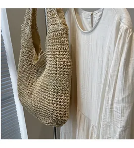 Detail of hand-woven straw tote bag with hollow pattern and soft inner lining