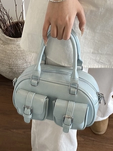 Light blue patent leather bowling bag with silver buckles and a stylish cargo design