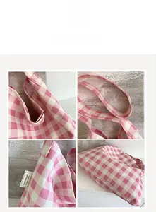 Detailed close-up showing the pink checkered fabric texture and brand label of the tote bag