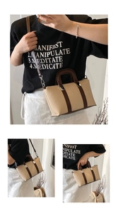 Detail of woven small tote bag with brown leather handles and removable shoulder strap