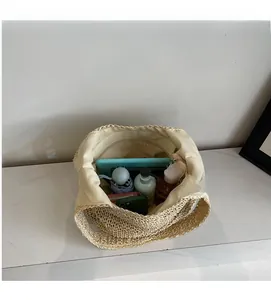 Top view showing large interior capacity of straw tote bag with daily essentials