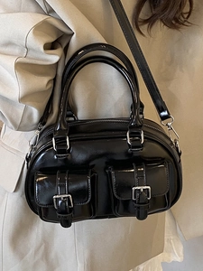 Elegant black patent leather bowling bag with dual front buckles and crossbody strap