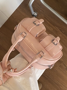 Pink Boston bowling handbag with double front pockets and sleek silver metal hardware