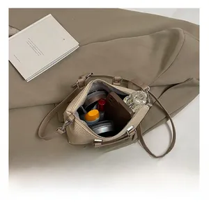 Detailed view of internal storage showing space for perfume, phone and cosmetics