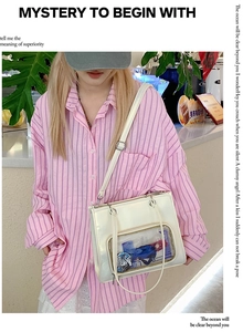 White oil wax leather shoulder bag with large transparent window on cafe counter