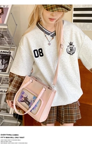 Pink ita bag with a large transparent display window and adjustable crossbody strap