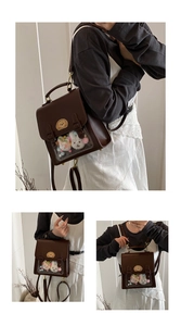 Detail of dark brown faux leather backpack with clear window and golden metal buckles