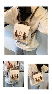 Detail view of British style backpack with transparent window and colorful plush charms