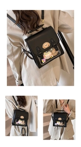 Detail view of the black Cambridge-style backpack with a clear window and plush decor