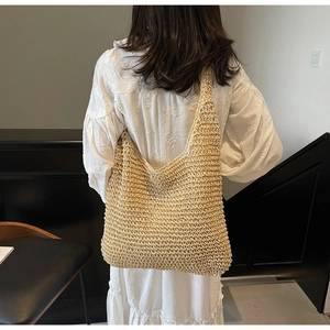 Detailed close-up showing the intricate woven texture of this large straw beach tote bag