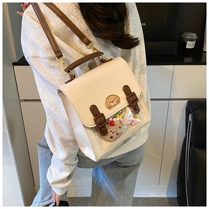 Detail view of the cream and brown PU leather crossbody bag with a clear window for plushies