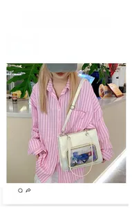 Detailed view of white faux leather tote bag with transparent display pocket