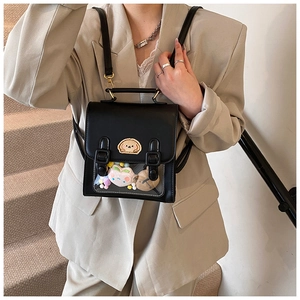 Detail of black faux leather backpack with clear PVC window and plush toy inserts