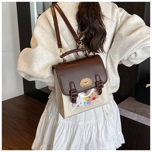 British style vintage brown and cream backpack with clear window and plush dog toy detail