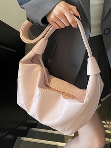 Minimalist soft leather crescent tote bag in pale pink with embossed texture for women