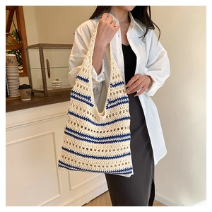 Close-up of hollow crochet texture and blue stripes on the woven tote bag