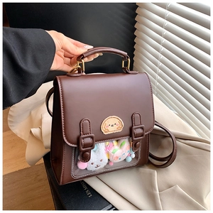 Detail of vintage dark brown faux leather backpack with clear window and cute embroidery