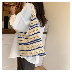 Detail of cream crochet tote bag with blue stripes showing hand-woven texture and design