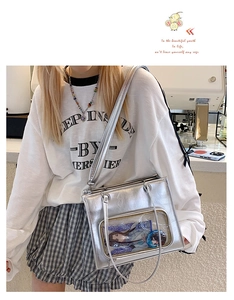 Detail showing shiny silver ita bag with clear PVC window for character badges and cards