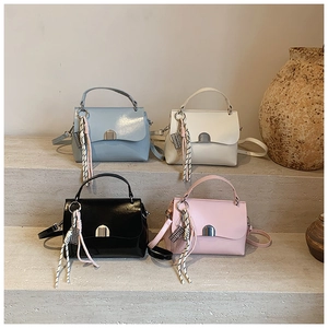 Detailed group view of four glossy minimalist tote bags in blue, white, black, and pink colors