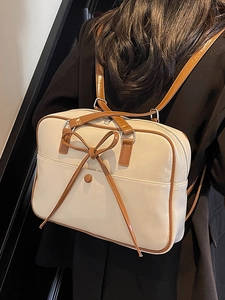 Cream chic bow tote backpack with contrast brown trim and shiny patent finish