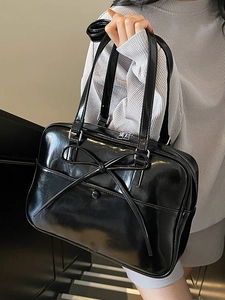 Minimalist black patent leather ballet style tote bag with bow detail and silver zipper